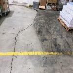 Warehouse concrete floor mid-clean with CreteClean Plus showing contrast between soiled and cleaned sections