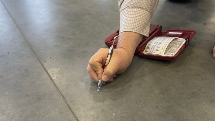 Close up of Mohs pencil hardness test being performed on Type 1L concrete floor.