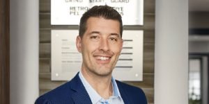 Headshot of Marco Poggio standing in Curecrete's lobby.