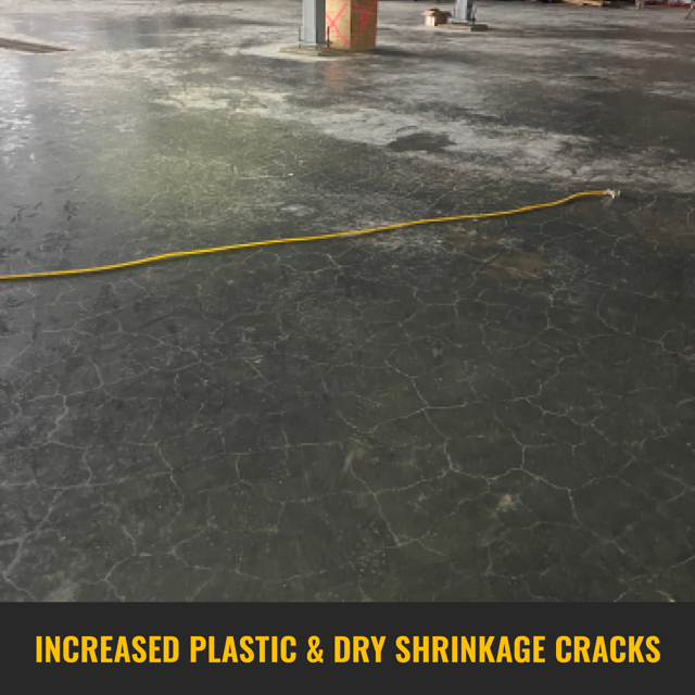 Pervasive dry shrinkage cracks spanning the entirety of the concrete surface with yellow extension cord laying in the middle of the floor.